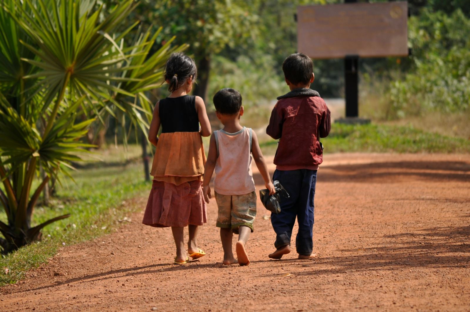 Children walking on a street near Angkor Wat (Photo by Unsplash)
